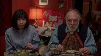 Movie still from “About Schmidt” (2002), directed by Alexander Payne – A man and a woman sitting at a dinner table; Medium shot, Low angle