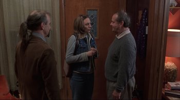 Movie still from “About Schmidt” (2002), directed by Alexander Payne – A woman talking to two men in front of a door; Medium shot, Over the shoulder angle