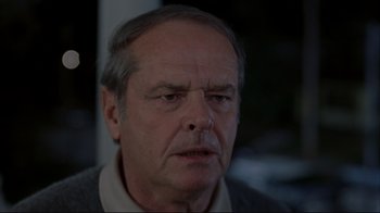 Movie still from “About Schmidt” (2002), directed by Alexander Payne – An older man is looking into the camera; Close Up shot, Over the shoulder angle
