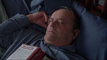 Movie still from “About Schmidt” (2002), directed by Alexander Payne – A person laying in a bed with a book; Close Up shot, High angle