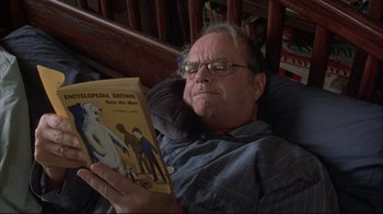 Movie still from “About Schmidt” (2002), directed by Alexander Payne – An older man is reading a book in a chair; Close Up shot, Low angle