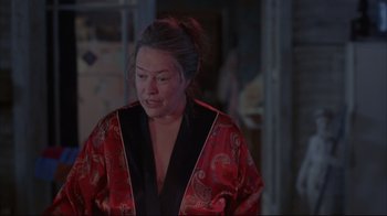 Movie still from “About Schmidt” (2002), directed by Alexander Payne – A woman in a red and black kimono; Medium shot, Over the shoulder angle