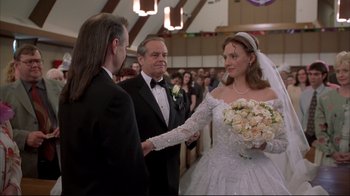 Movie still from “About Schmidt” (2002), directed by Alexander Payne – A woman in a wedding dress holding a bouquet of flowers in front of two men; Close Up shot, Over the shoulder angle