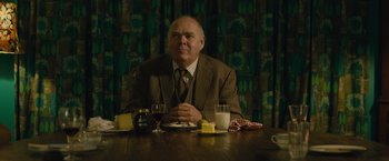 Movie still from “About Time” (2013), directed by Richard Curtis – A man sitting at a table with a glass of milk; Medium shot, Over the shoulder angle