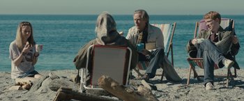 Movie still from “About Time” (2013), directed by Richard Curtis – Two people sitting on lawn chairs on the beach; Medium shot, Over the shoulder angle