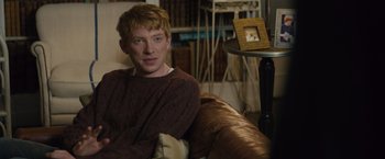 Movie still from “About Time” (2013), directed by Richard Curtis – A man sitting on a couch in a living room; Medium shot, Over the shoulder angle