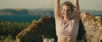 Movie still from “About Time” (2013), directed by Richard Curtis – A beautiful young lady smiling while standing on top of a hill; Medium shot, Low angle