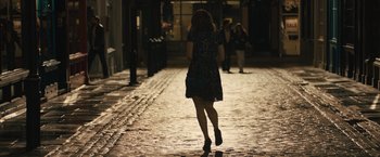 Movie still from “About Time” (2013), directed by Richard Curtis – A woman walking down a street at night; Wide shot, High angle