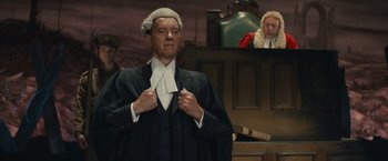 Movie still from “About Time” (2013), directed by Richard Curtis – A man in a judge's wig and wig stands in front of a judge; Medium shot, Low angle