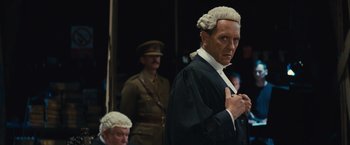 Movie still from “About Time” (2013), directed by Richard Curtis – A man in a judge's wig standing in front of other men in military uniforms; Medium shot, Low angle