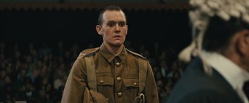 Movie still from “About Time” (2013), directed by Richard Curtis – A man in a military uniform standing in front of a crowd of onlookers; Close Up shot, Over the shoulder angle