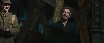 Movie still from “About Time” (2013), directed by Richard Curtis – A man in a suit and tie looking up; Medium shot, Over the shoulder angle