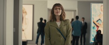 Movie still from “About Time” (2013), directed by Richard Curtis – A woman in a green jacket standing in front of a group of people; Medium shot, Over the shoulder angle