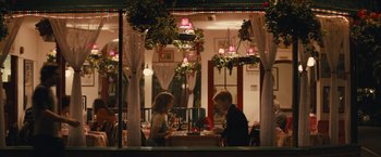 Movie still from “About Time” (2013), directed by Richard Curtis – A man and a woman standing at a table in front of a window; Wide shot, Over the shoulder angle