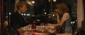 Movie still from “About Time” (2013), directed by Richard Curtis – A man and a woman sitting at a table drinking wine; Medium shot, Over the shoulder angle