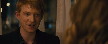 Movie still from “About Time” (2013), directed by Richard Curtis – A man with red hair is smiling at the camera; Close Up shot, Over the shoulder angle