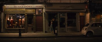 Movie still from “About Time” (2013), directed by Richard Curtis – A woman and a little girl standing in front of a store; Wide shot, High angle