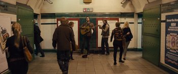 Movie still from “About Time” (2013), directed by Richard Curtis – A group of people standing in a subway station; Wide shot, High angle