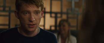 Movie still from “About Time” (2013), directed by Richard Curtis – A man with red hair is looking at the camera while a woman looks on; Close Up shot, Over the shoulder angle