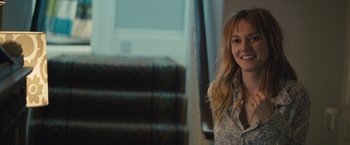 Movie still from “About Time” (2013), directed by Richard Curtis – A woman sitting in front of a staircase smiling; Close Up shot, Over the shoulder angle