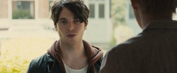 Movie still from “About Time” (2013), directed by Richard Curtis – A young man is looking into the camera; Close Up shot, Over the shoulder angle