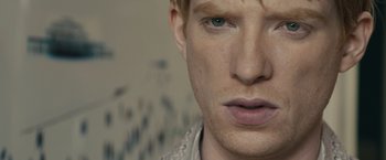 Movie still from “About Time” (2013), directed by Richard Curtis – A man's face with a lot of people in the background; Close Up shot, Over the shoulder angle