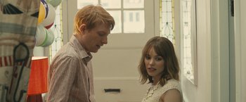 Movie still from “About Time” (2013), directed by Richard Curtis – A man and a woman standing next to each other in front of a window; Close Up shot, Over the shoulder angle