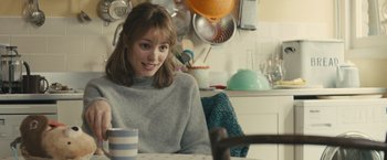 Movie still from “About Time” (2013), directed by Richard Curtis – A woman sitting at a table in a kitchen; Medium shot, Over the shoulder angle