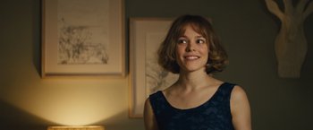 Movie still from “About Time” (2013), directed by Richard Curtis – A woman in a blue dress smiling for the camera; Close Up shot, Over the shoulder angle