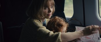 Movie still from “About Time” (2013), directed by Richard Curtis – A woman sitting in a car holding a child; Close Up shot, Over the shoulder angle