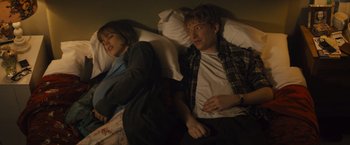 Movie still from “About Time” (2013), directed by Richard Curtis – A man and a woman laying in bed next to each other; Medium shot, Overhead angle