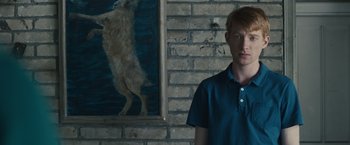 Movie still from “About Time” (2013), directed by Richard Curtis – A man standing in front of a painting of a dog; Medium shot, Over the shoulder angle