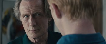 Movie still from “About Time” (2013), directed by Richard Curtis – An older man looking at a younger man in a mirror; Close Up shot, Over the shoulder angle