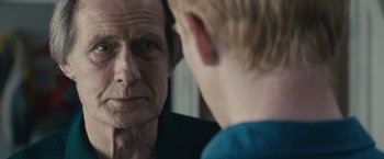 Movie still from “About Time” (2013), directed by Richard Curtis – An older man looking at a young boy in a mirror; Close Up shot, Over the shoulder angle