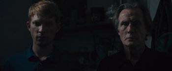 Movie still from “About Time” (2013), directed by Richard Curtis – Two people in a dark room looking at the camera; Close Up shot, Over the shoulder angle