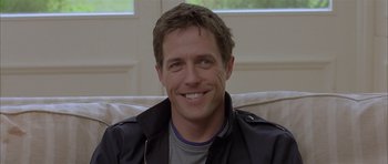 Movie still from “About a Boy” (2002), directed by Chris Weitz – A person sitting on a couch; Close Up shot, Over the shoulder angle