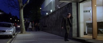 Movie still from “About a Boy” (2002), directed by Chris Weitz – A man walking down a sidewalk at night; Wide shot, Low angle