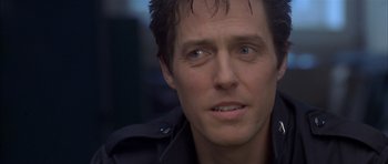 Movie still from “About a Boy” (2002), directed by Chris Weitz – A person wearing a black jacket; Close Up shot, Over the shoulder angle