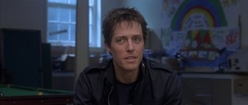 Movie still from “About a Boy” (2002), directed by Chris Weitz – A person wearing a black jacket; Close Up shot, Over the shoulder angle