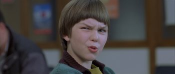 Movie still from “About a Boy” (2002), directed by Chris Weitz – A young boy making a funny face with his mouth open; Close Up shot, Low angle