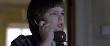 Movie still from “About a Boy” (2002), directed by Chris Weitz – A young boy is talking on a phone; Close Up shot, Low angle