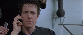 Movie still from “About a Boy” (2002), directed by Chris Weitz – A person getting his hair combed back; Close Up shot, Over the shoulder angle