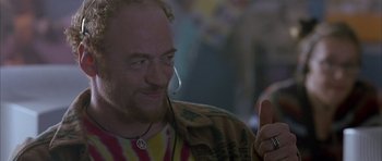 Movie still from “About a Boy” (2002), directed by Chris Weitz – A man with a beard is holding a microphone; Close Up shot, Low angle