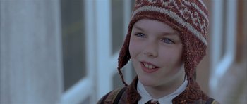 Movie still from “About a Boy” (2002), directed by Chris Weitz – A young boy wearing a hat and a tie; Close Up shot, Over the shoulder angle