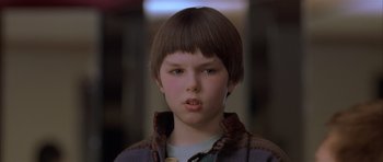 Movie still from “About a Boy” (2002), directed by Chris Weitz – A young boy with short brown hair wearing a jacket; Close Up shot, Low angle