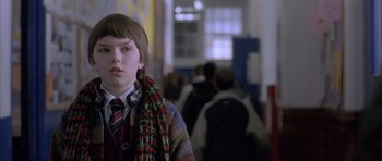 Movie still from “About a Boy” (2002), directed by Chris Weitz – A young boy wearing a scarf and a tie; Close Up shot, Low angle
