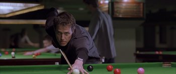 Movie still from “About a Boy” (2002), directed by Chris Weitz – A man playing a game of pool in a bar; Medium shot, Over the shoulder angle