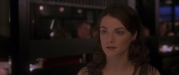 Movie still from “About a Boy” (2002), directed by Chris Weitz – A beautiful woman sitting in front of a group of people; Close Up shot, Over the shoulder angle