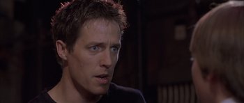 Movie still from “About a Boy” (2002), directed by Chris Weitz – A person wearing a black t - shirt; Close Up shot, Low angle