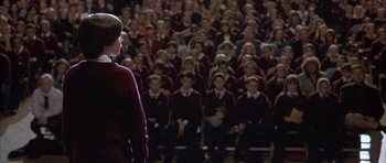 Movie still from “About a Boy” (2002), directed by Chris Weitz – A group of people standing in front of each other; Wide shot, High angle